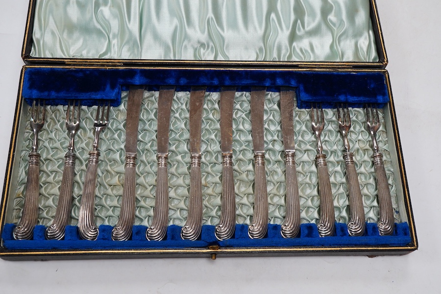 A cased set of six pairs of silver pistol handled dessert eaters, by James Dixon & Sons Ltd, Sheffield, 1905, knife 16.6cm.